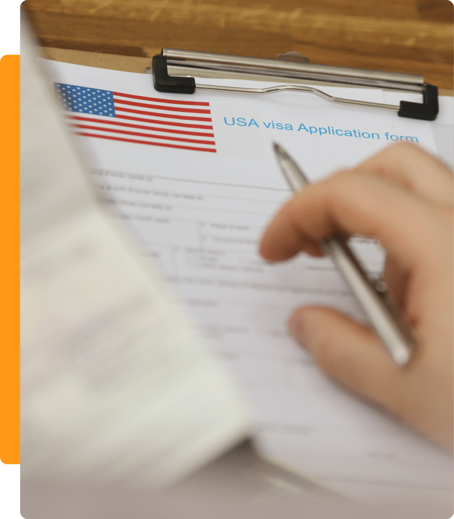 1 A person holding a pen over a visa application